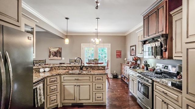 kitchen with hanging light fixtures, sink, light stone countertops, appliances with stainless steel finishes, and a notable chandelier