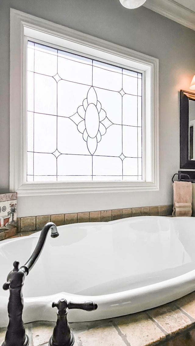 bathroom with a healthy amount of sunlight and crown molding