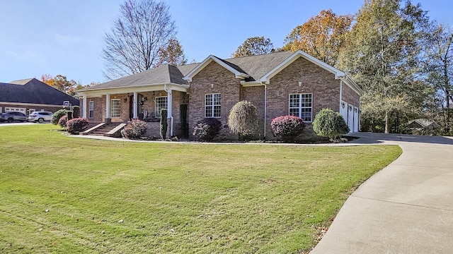 view of front facade with covered porch, a garage, and a front yard