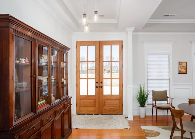 foyer with french doors, light wood-style floors, and a healthy amount of sunlight