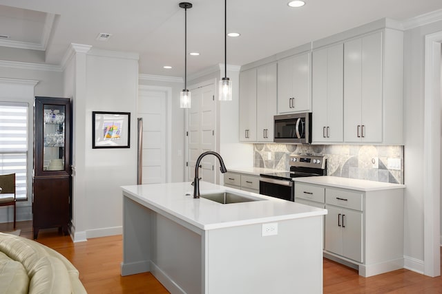 kitchen with decorative backsplash, appliances with stainless steel finishes, crown molding, and a sink