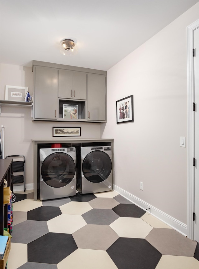 laundry area featuring tile patterned floors, cabinet space, independent washer and dryer, and baseboards