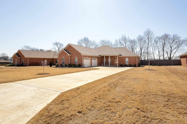 single story home with concrete driveway, an attached garage, fence, and brick siding