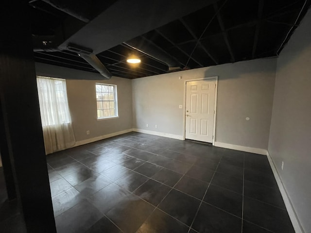 basement featuring dark tile patterned floors