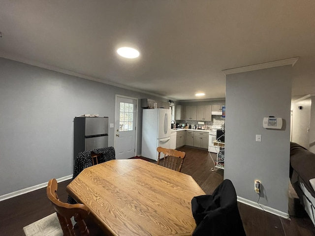 dining room with crown molding and dark hardwood / wood-style floors