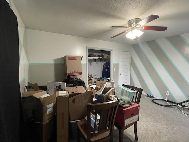 carpeted office featuring ceiling fan and a textured ceiling