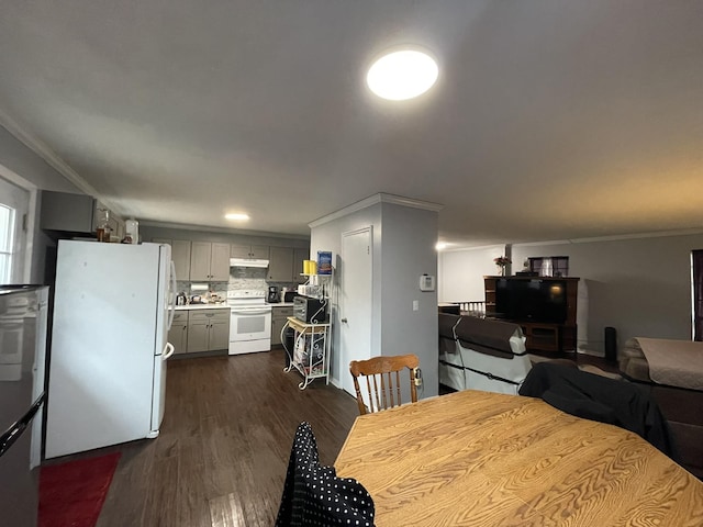 dining area featuring dark hardwood / wood-style flooring and crown molding