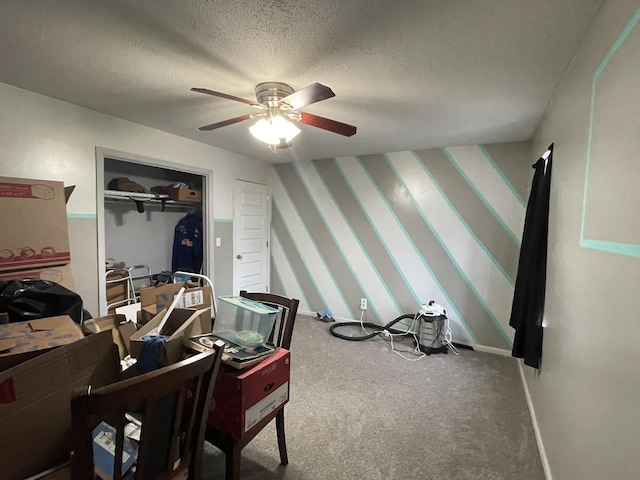 interior space with ceiling fan, carpet floors, and a textured ceiling