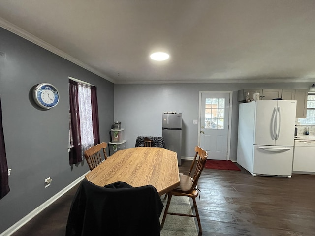 dining space featuring ornamental molding and dark hardwood / wood-style flooring