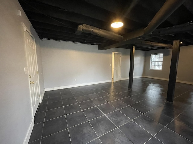 basement featuring dark tile patterned floors