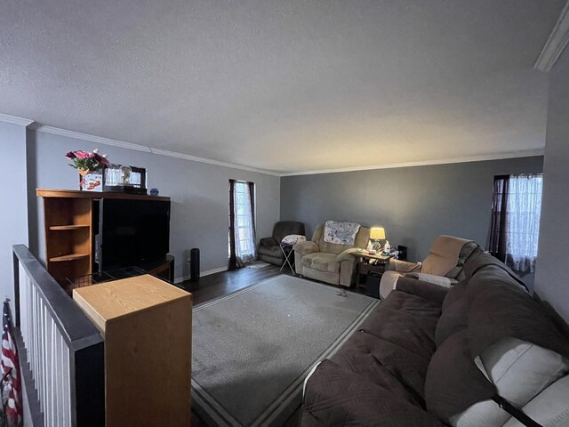 living room with ornamental molding, a healthy amount of sunlight, and hardwood / wood-style floors