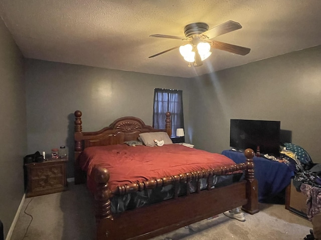 carpeted bedroom with a textured ceiling and ceiling fan