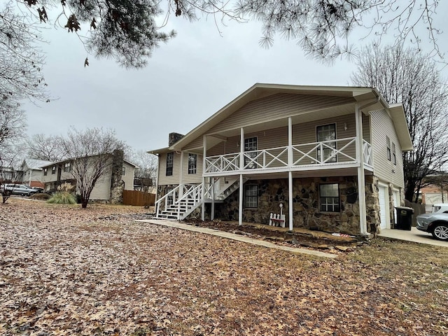 back of house featuring a garage and a porch