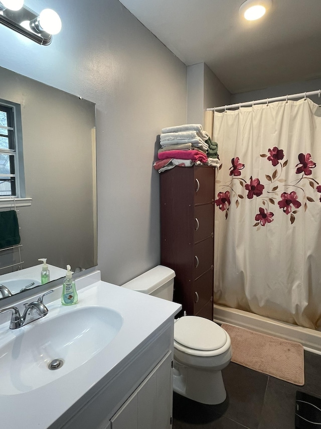 bathroom featuring tile patterned floors, toilet, and vanity