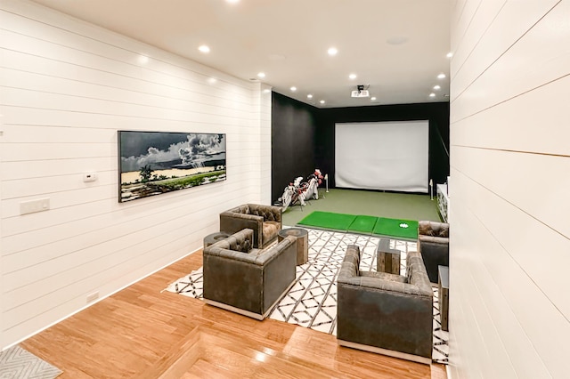  - playroom featuring golf simulator, wood finished floors, recessed lighting, and wooden walls