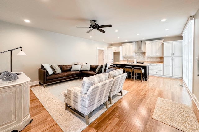  - living area with a ceiling fan, light wood-type flooring, and recessed lighting