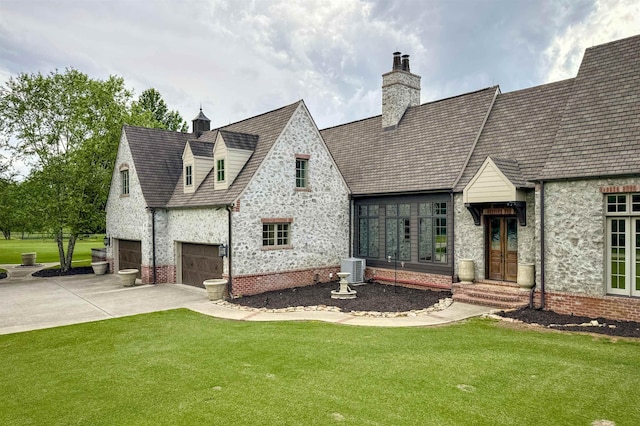  - view of front of house featuring driveway, a front lawn, and a chimney