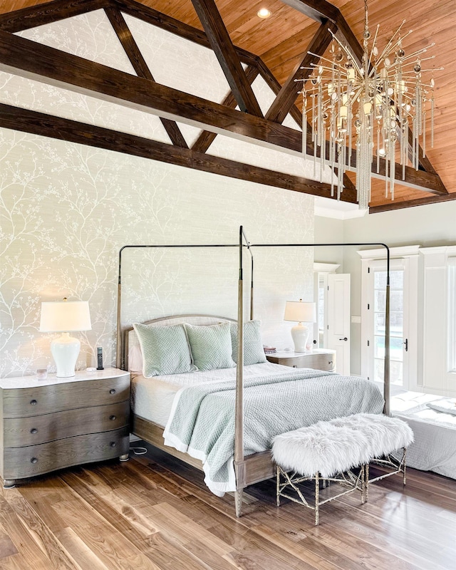  - bedroom featuring wallpapered walls, wood finished floors, and a chandelier