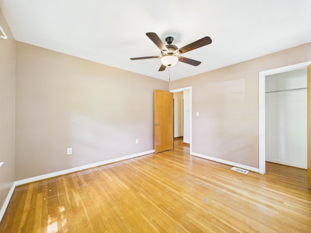  - unfurnished bedroom featuring light wood-style flooring, a ceiling fan, and a closet