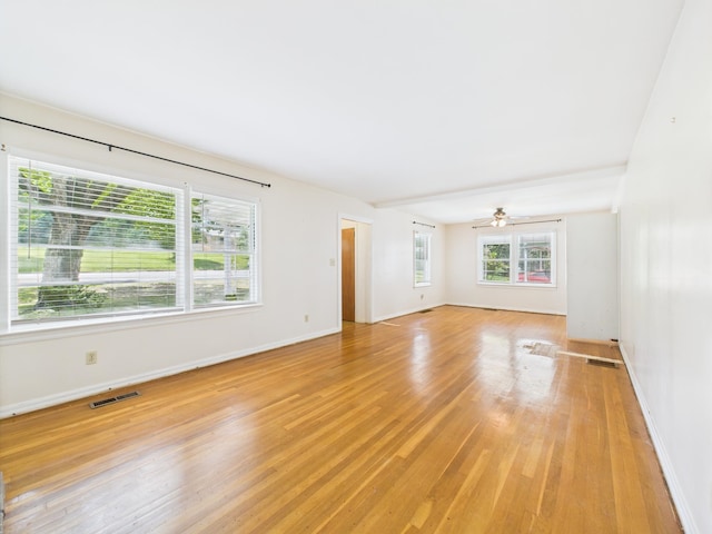  - spare room with light wood finished floors and ceiling fan
