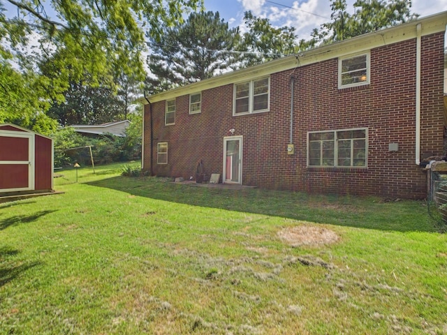  - rear view of house with a storage shed, a lawn, and brick siding
