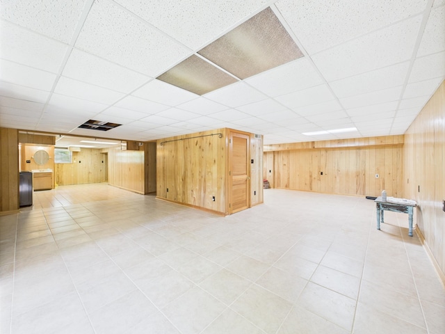  - finished below grade area with wooden walls and a paneled ceiling