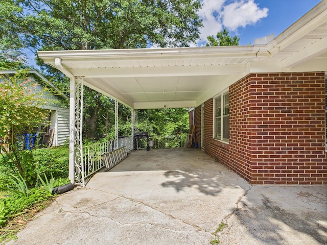  - view of patio featuring driveway and an attached carport