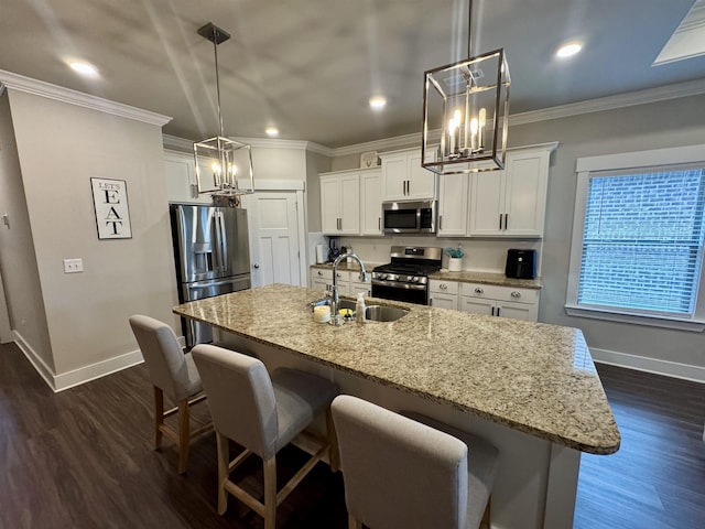 kitchen with baseboards, a sink, appliances with stainless steel finishes, and a chandelier