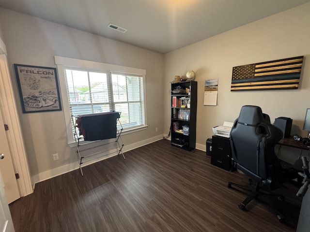 office space with visible vents, baseboards, and dark wood-style flooring