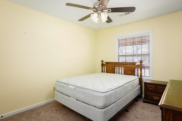 carpeted bedroom featuring visible vents, baseboards, and ceiling fan