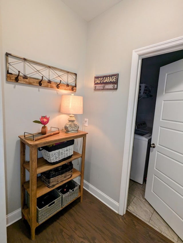  - corridor with wood finished floors and washer / clothes dryer
