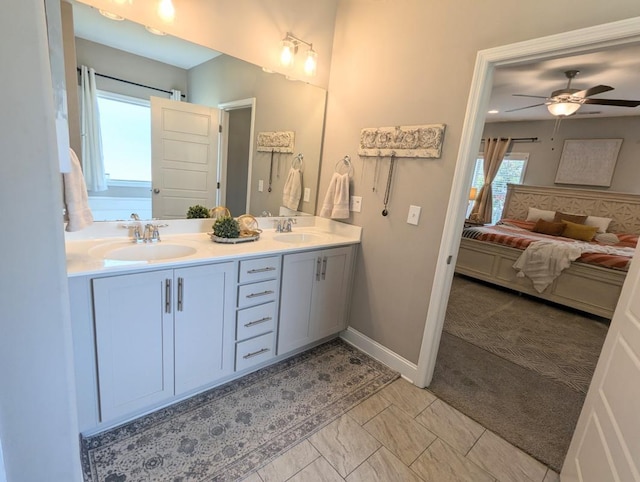  - bathroom featuring double vanity, connected bathroom, healthy amount of natural light, and ceiling fan