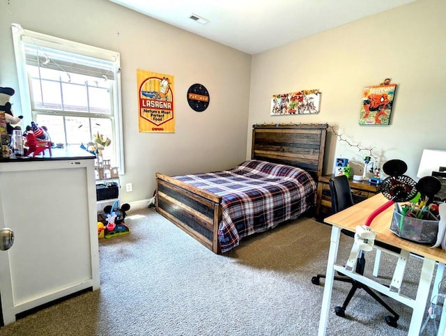  - carpeted bedroom with a desk
