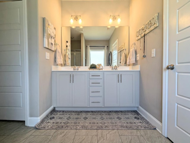  - bathroom featuring double vanity and a shower