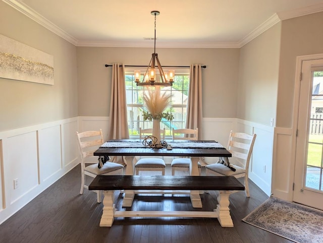  - dining room with a chandelier, wainscoting, ornamental molding, dark wood finished floors, and a decorative wall