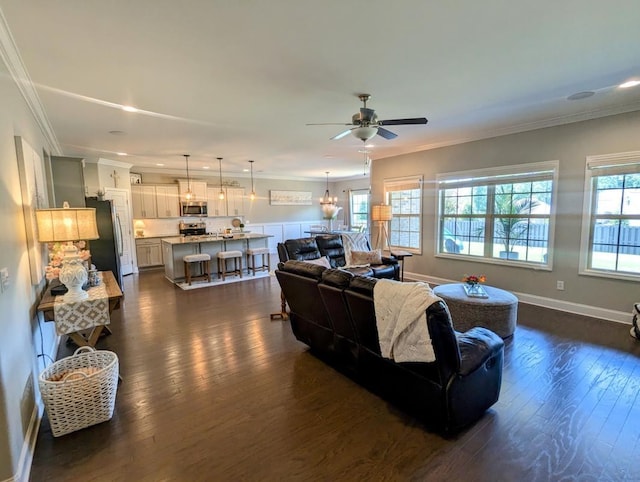  - living room featuring dark wood-style flooring, ornamental molding, a ceiling fan, a chandelier, and recessed lighting