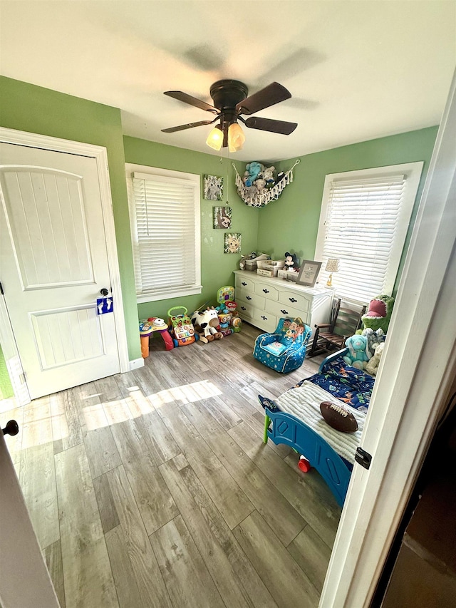  - bedroom featuring wood finished floors and ceiling fan