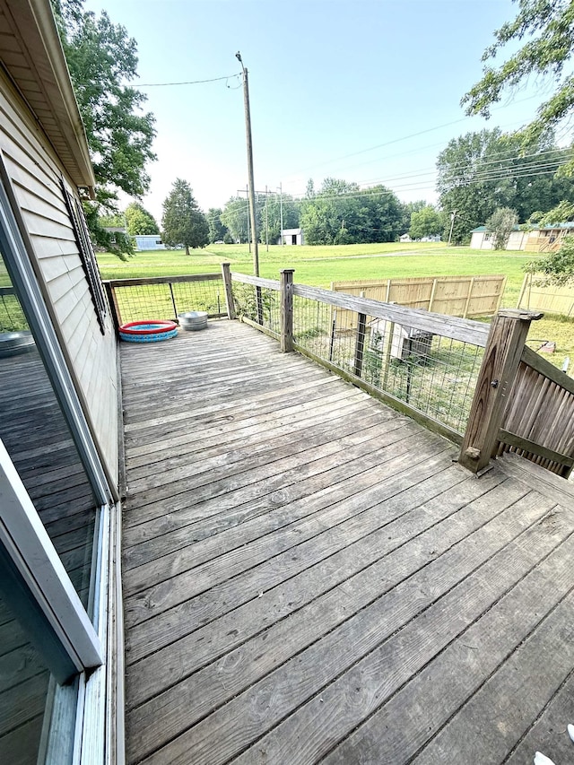  - wooden deck with a view of rural / pastoral area and a lawn