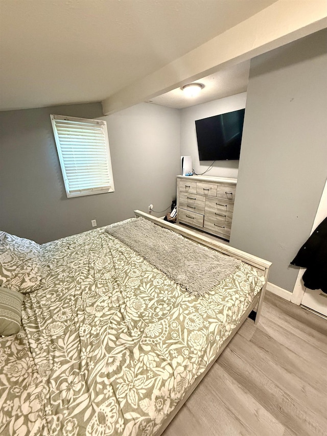  - bedroom featuring light wood finished floors and baseboards