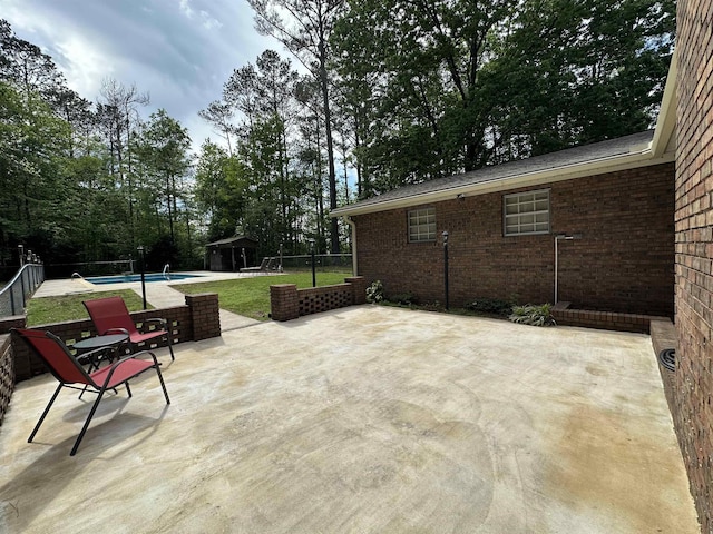 view of patio with a fenced in pool, an outdoor structure, and a fenced backyard