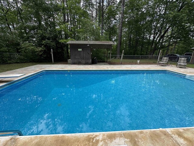 view of swimming pool with a fenced in pool and fence