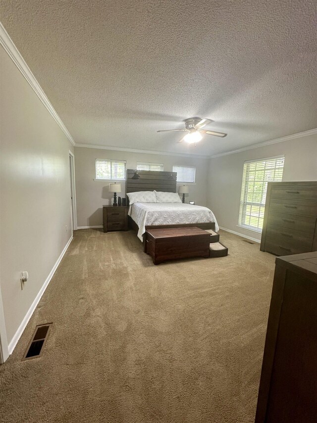  - bedroom featuring visible vents, ornamental molding, carpet, and a textured ceiling
