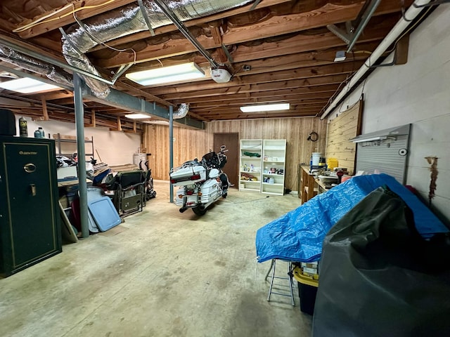 garage with a garage door opener and wood walls
