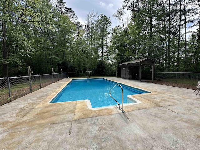 view of swimming pool with a gazebo, fence, a fenced in pool, and a patio