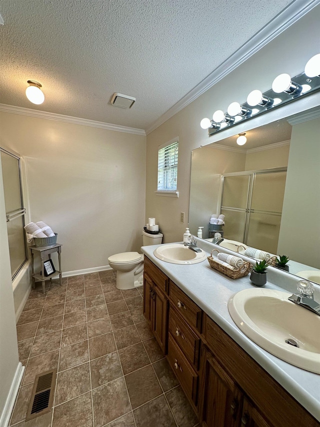 full bath featuring visible vents, a sink, double vanity, and toilet