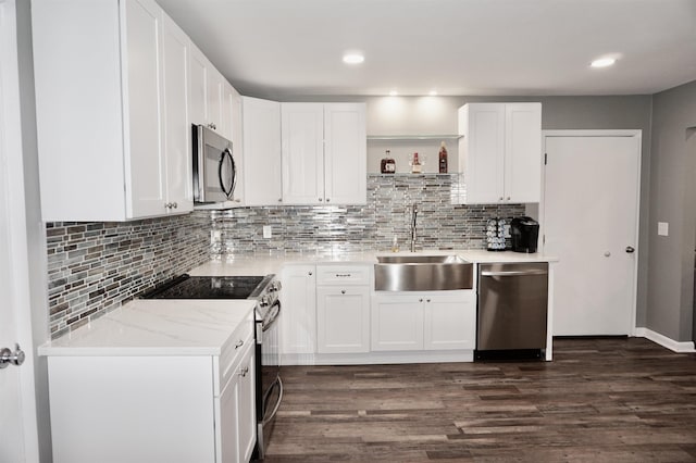 kitchen with sink, white cabinets, and appliances with stainless steel finishes