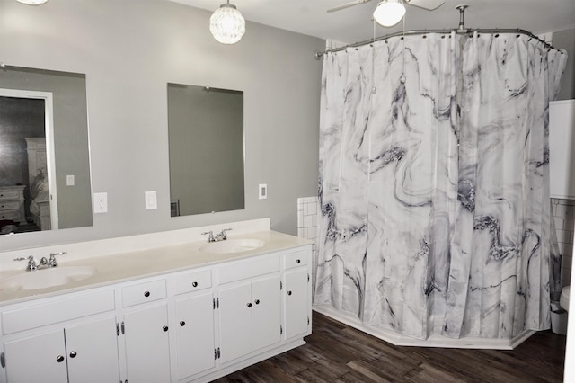 bathroom featuring a shower with shower curtain, wood-type flooring, vanity, and ceiling fan