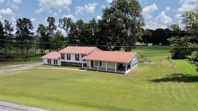 view of front of home featuring covered porch and a front yard