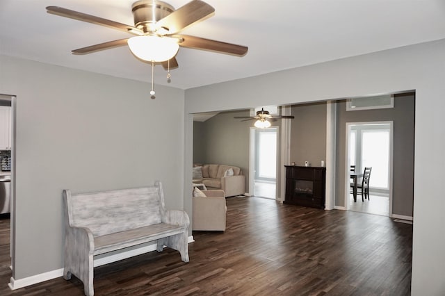 sitting room featuring ceiling fan and dark hardwood / wood-style floors