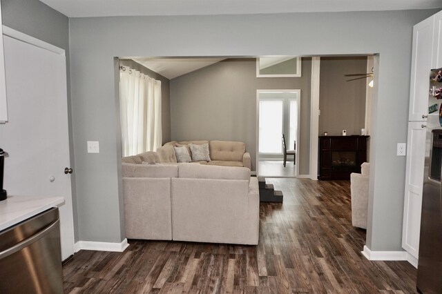 living room with ceiling fan, dark hardwood / wood-style flooring, and a fireplace